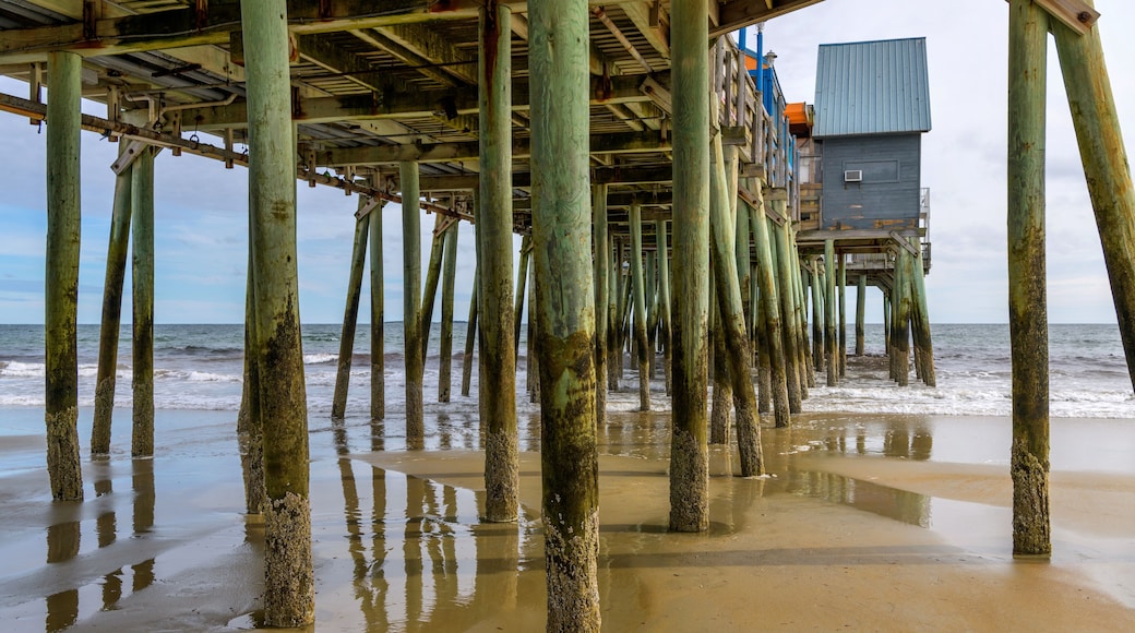 Under The Pier - Waves rushing in and out of sand beach under famous The Pier at Old Orchard Beach on a sunny Autumn morning. Maine, USA.