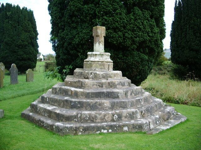Stone cross in St Oswald's parish churchyard, Dean, Cumbria, England