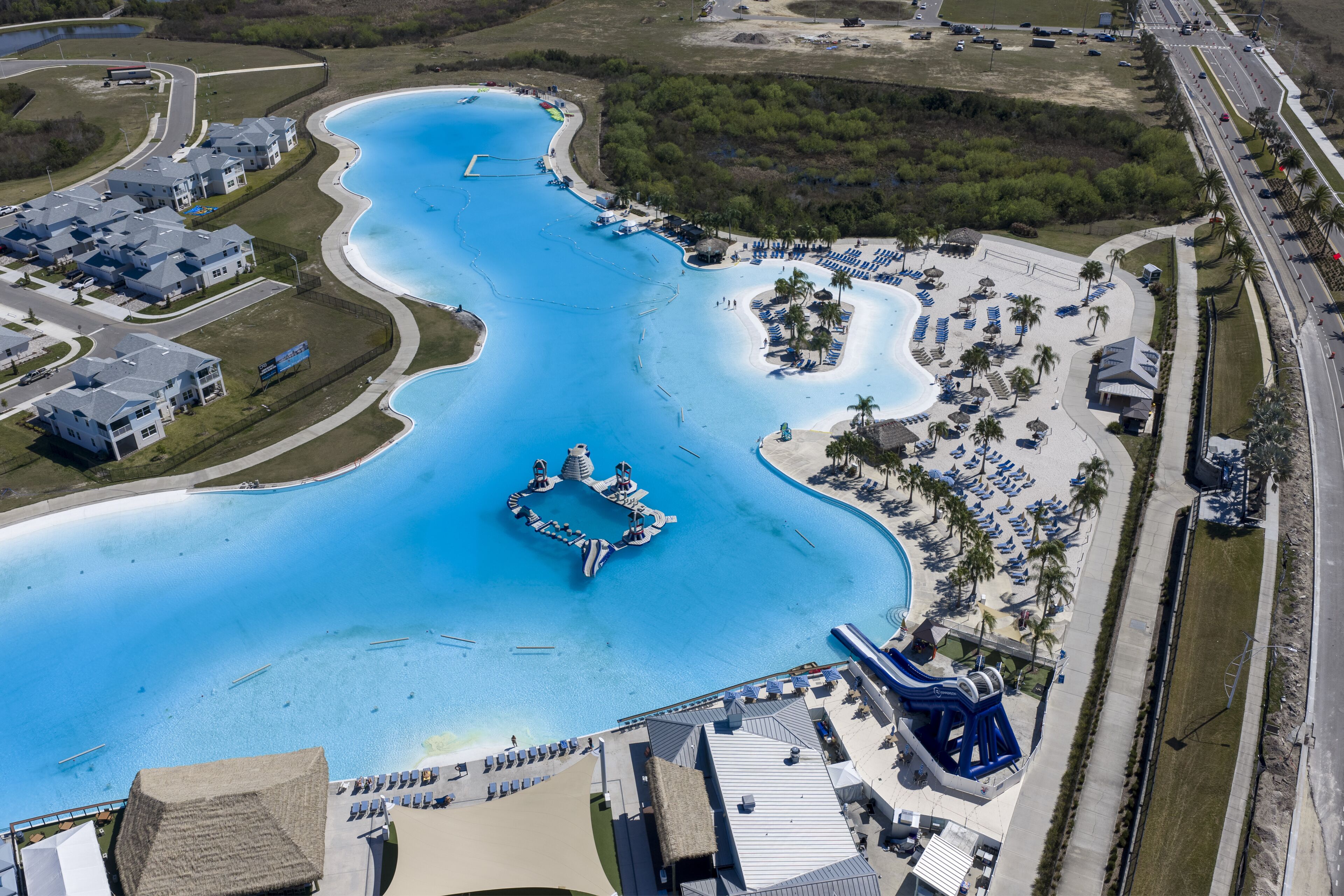 Wesley Chapel, United States - 02 March 2026: Aerial view of Epperson Lagoon with its turquoise water, white sandy beaches, and surrounding residential neighborhood.