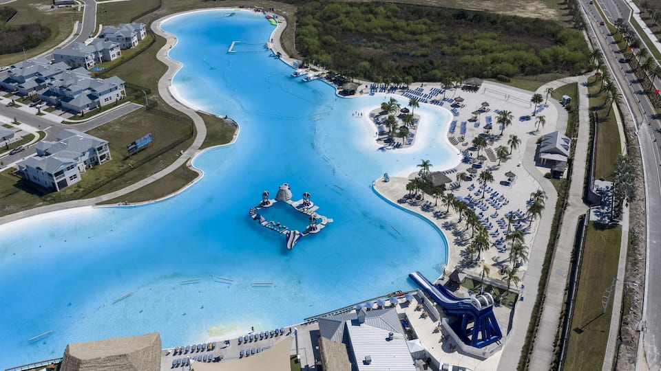 Wesley Chapel, United States - 02 March 2026: Aerial view of Epperson Lagoon with its turquoise water, white sandy beaches, and surrounding residential neighborhood.