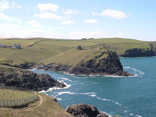 Across the entrance to Port Quin. The entrance to the old harbour of Port Quin is a narrow inlet. Across the other side at the centre of this photograph is Doyden Point on which stands Doyden Castle, an early example of a second home in Cornwall, built in 1830.
