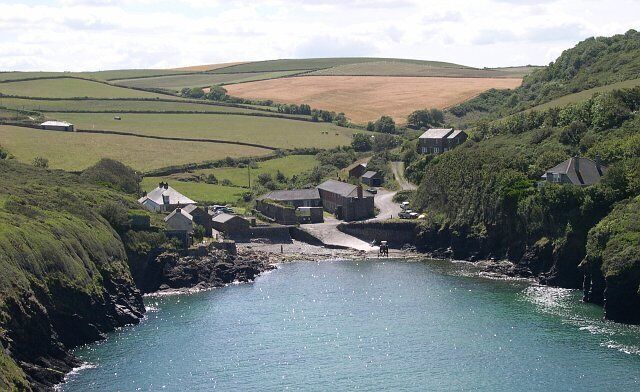 Port Quin and the fields beyond. The fishing village of Port Quin was abandoned sometime in the late 19th century and local legends tell of the day the men went fishing against advise and tradition (possibly on a Sunday) and were swept away by a huge storm. The truth is probably that the herring and pilchard fishing on which the village depended slowly declined in the latter half of the 19th century and at the same time small local mines closed down and the people slowly moved away or emigrated.