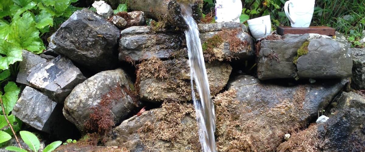 A small waterfall cascading over rocks in a garden.