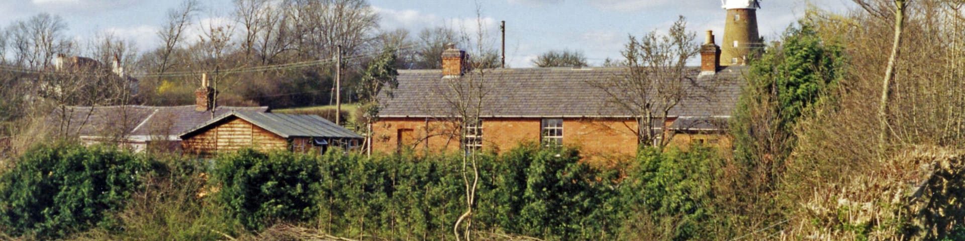 Remnants of railway buildings at Edmondthorpe & Wymondham, 1994. View northwards, across the former Saxby (left) - Bourne (right) line. To the left are the preserved Navvy Accommodation and behind can be seen Wymondham Windmill