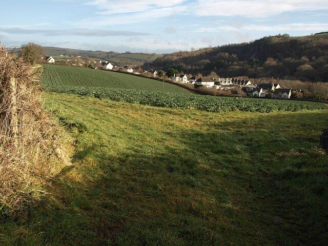 Housing on Timbers Road, Buckfastleigh. A view from the gateway shown in 1125853 across a field towards the Dean valley. The housing is on the southern outskirts of Buckfastleigh.