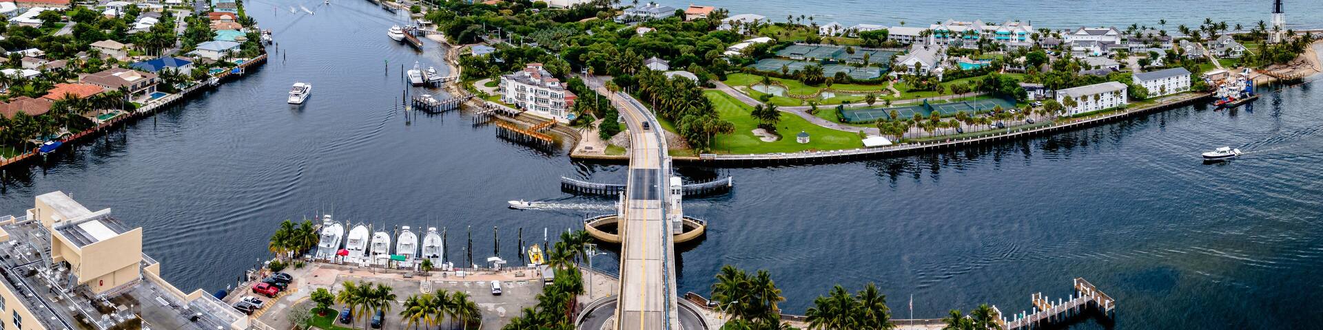 aerial drone shot of Hillsboro Inlet, Florida with bridge in city