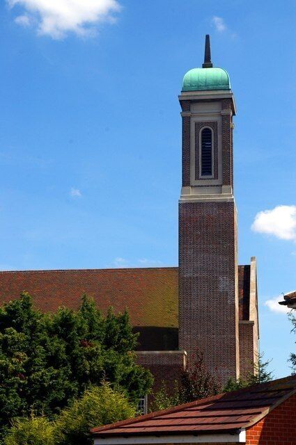 Southwest tower of St George's parish church, Chesterfield Road, Chesterton, Cambridge, England, seen from the west over a house roof in Eaton Close