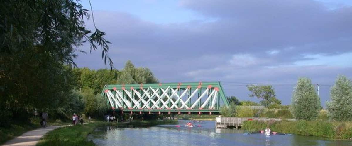 Heading for the start Eights make their way under the railway bridge on their way to the start of a City Bumps race