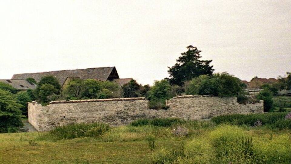 Slade Green, Howbury Moat. The walls of Howbury Moat date back to the 12th century, although a manor house occupied the site well over a thousand years ago. Several rebuilds occurred over the years, and notable occupants include Odo, Bishop of Bayeux and the distinguished admiral, Sir Cloudesley Shovel. The last house to occupy the site was of 17th century build, inhabited until 1935 after which, it fell into ruin. Behind the moated area to the left can be seen the 17th century tithe barn.