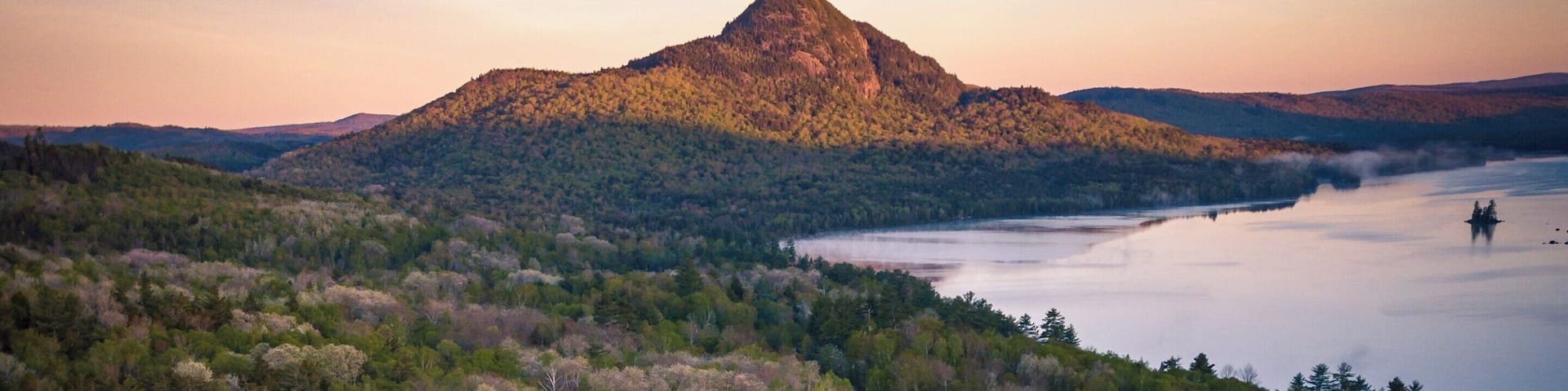 Aerial shot from a couple hundred feet above the Onawa Trestle looking back at Borestone Mountain at sunrise