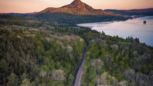 Aerial shot from a couple hundred feet above the Onawa Trestle looking back at Borestone Mountain at sunrise