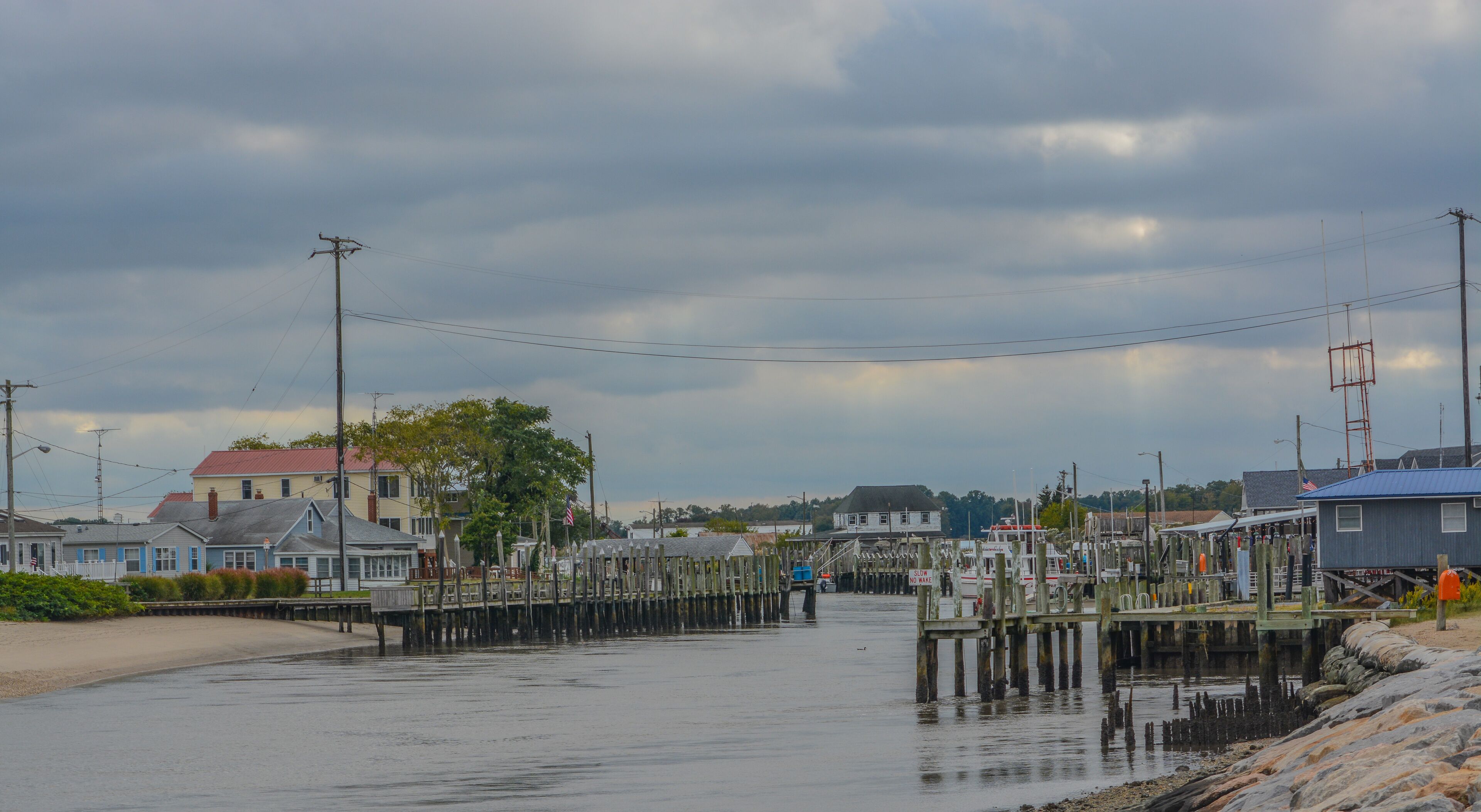 A waterfront town with wooden docks and houses.
