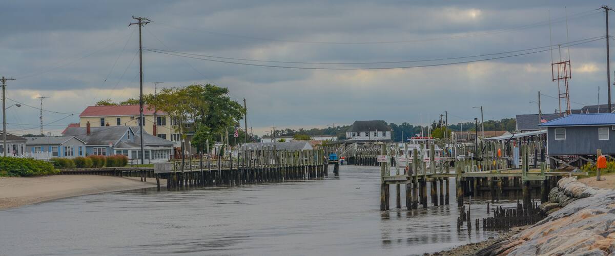 A waterfront town with wooden docks and houses.