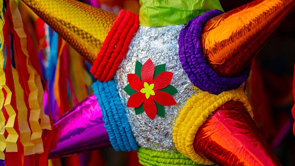 A colorful piñata with a large flower design.