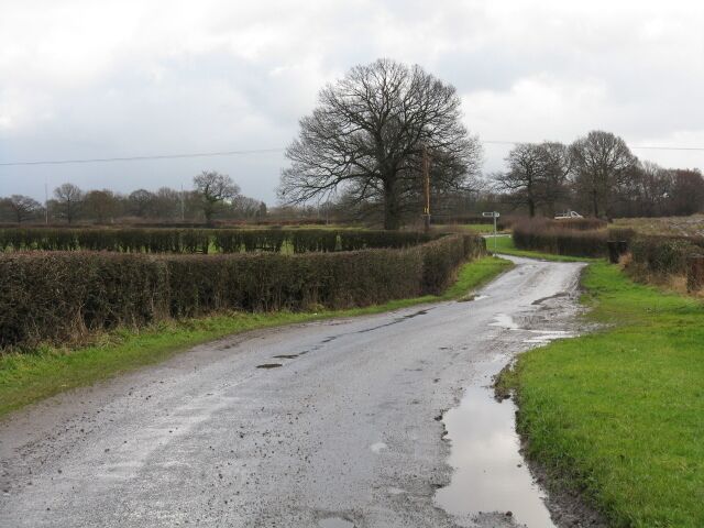 Deceptively Rural This muddy, rural lane is one of several back routes to Manchester's busy airport which is only a few hundred yards on the left.