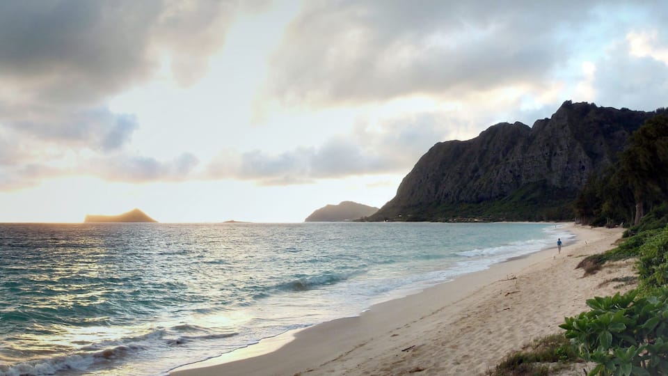 Early Morning Sunrise on Waimanalo Beach over Rock Island bursting through the clouds