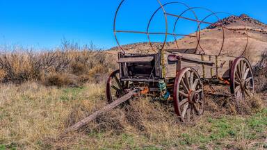 Old wagon standing with grace off National Back Country Byway ~ Highway 27 in NM.