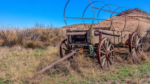Old wagon standing with grace off National Back Country Byway ~ Highway 27 in NM.