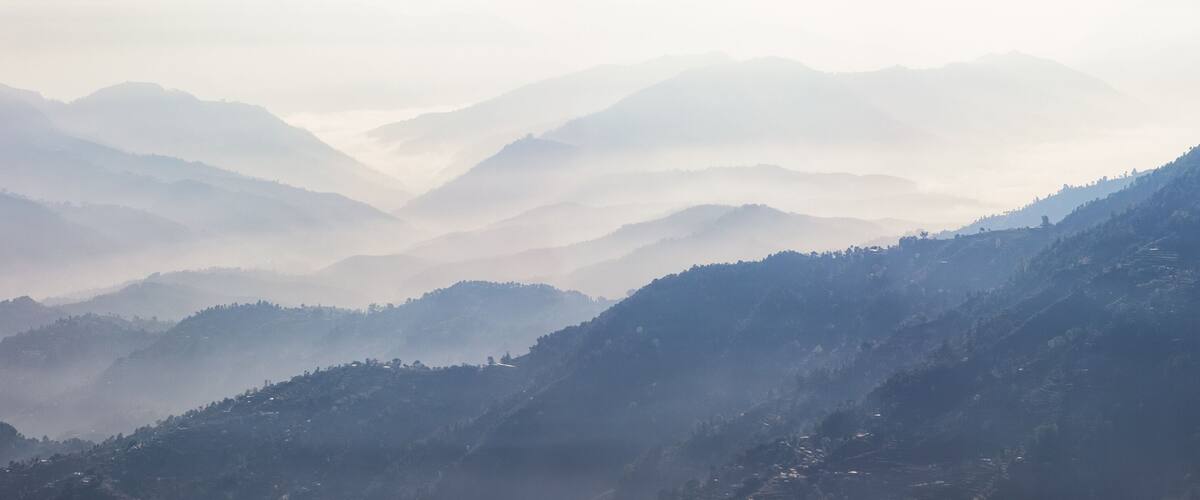 A mountainous landscape with layered hills and valleys.