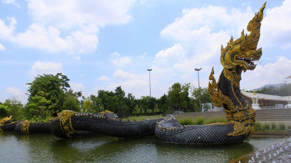 A large dragon sculpture in a body of water.