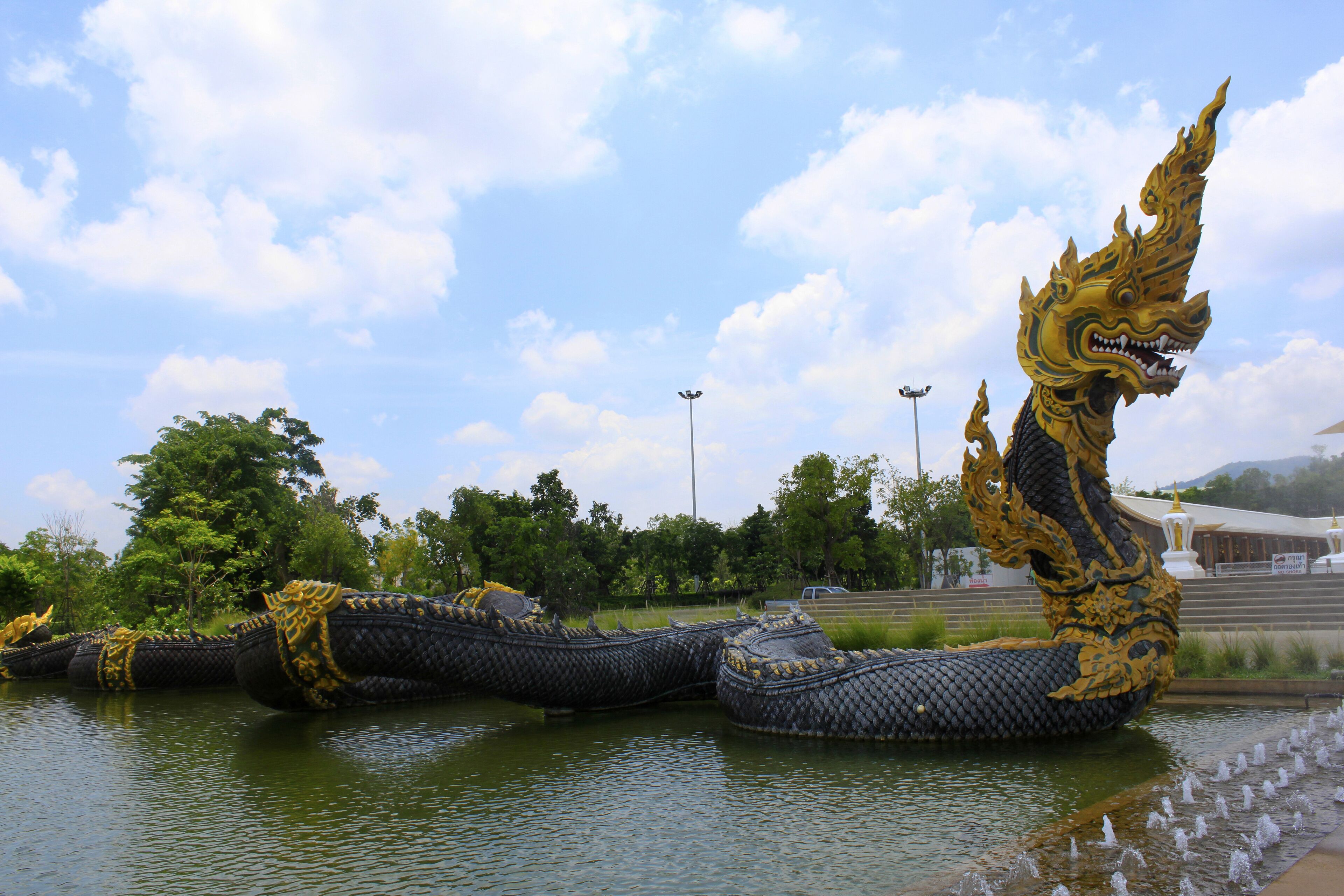 A large dragon sculpture in a body of water.