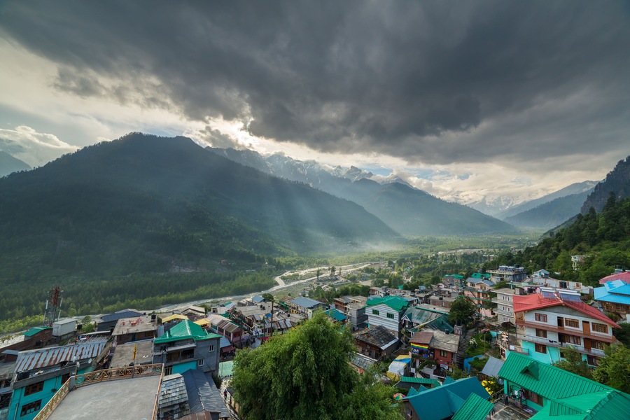 A mountainous landscape with a village nestled in the valley.