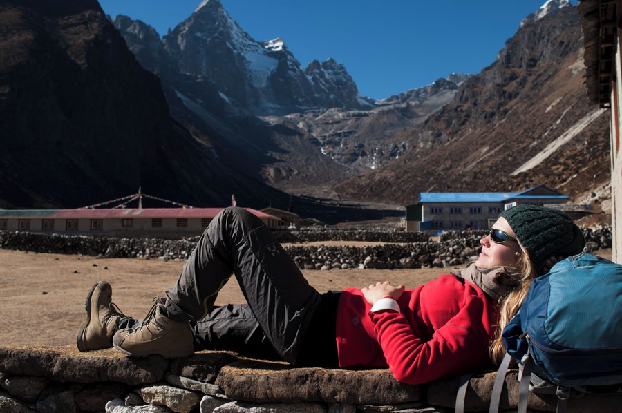 A trekker takes a break in the sun at Merchulu in the Everest region