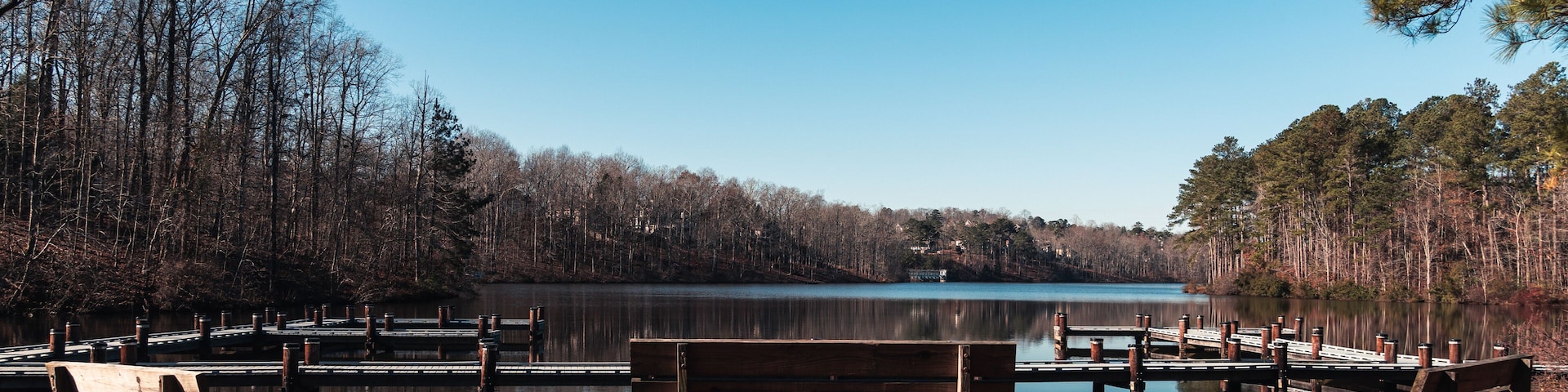 A lakeside park with wooden benches and docks.