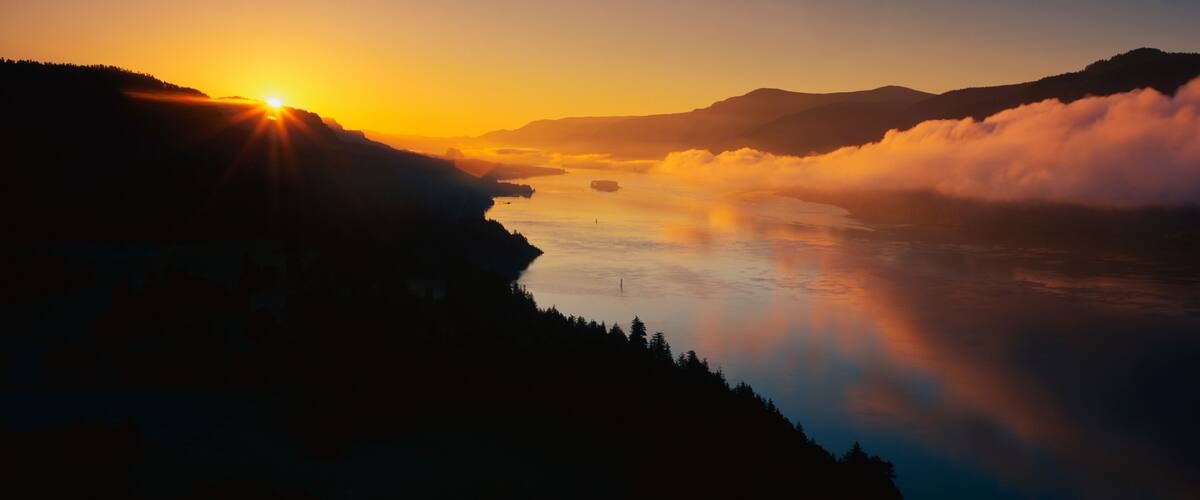 This is Cape Horn on the Columbia River Gorge at sunrise. There is a morning mist over the river.