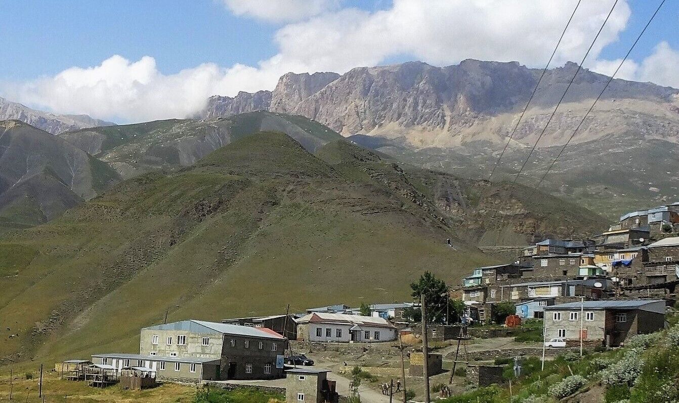 A mountainous landscape with a village nestled in the valley.