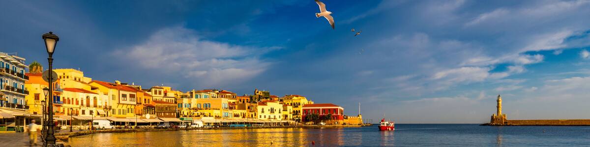 Old port of Chania with flying seagulls. Landmarks of Crete island. Bay of Chania at sunny summer day, Crete Greece. View of the old port of Chania, Crete, Greece. The port of chania, or Hania.