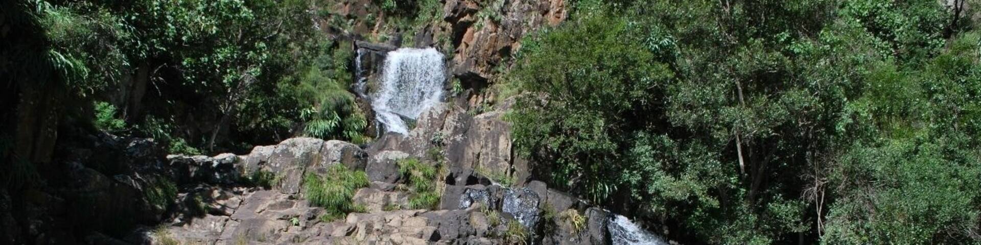 This waterfall is a hidden gem in the Drakensberg. The park and surrounding area has magnificent scenery, beautiful waterfalls/rivers and great trekking. Lotheni Nature Reserve is in the remote section of the Ukhahlamba Drakensberg mountains, South Africa.
There are many great walking trails, but be sure to get there early and plan accordingly as it is out of the way and you have to drive on dust roads with no gas/petrol stations for at least 40-70km.
We were told that the Jacobs ladder hike was about 2-3 hours round trip. Unfortunately we arrived too late in the day to do the hike, so instead we went swimming in the fresh water pools.
After talking with some locals, they directed us up stream where we found this lovely waterfall.
Absolutely breathtaking and what a surprise. We were the only people there to enjoy the lovely, cold mountain waters. There are three pools to this waterfall and the top pool was difficult to access due to the terrain.
If you do go to this area and enjoy hiking, waterfalls and all the natural beauty, be sure to give yourself some time so you can make the most of the area.
#Nationalpark