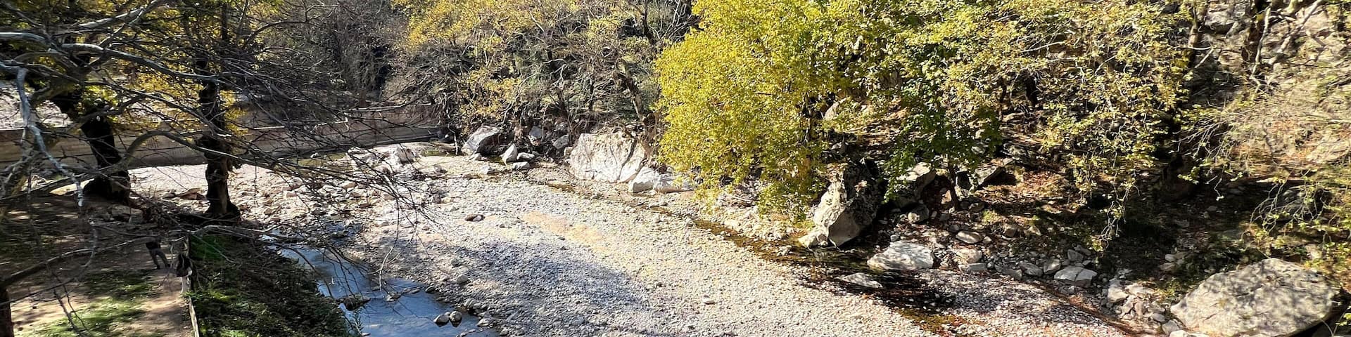 Scenic view of the Portaikos River from Portaikos Bridge, nestled in the beautiful Meteora-Pyli Geopark in Trikala, Thessaly, Greece’s newest addition to the UNESCO Global Geoparks.