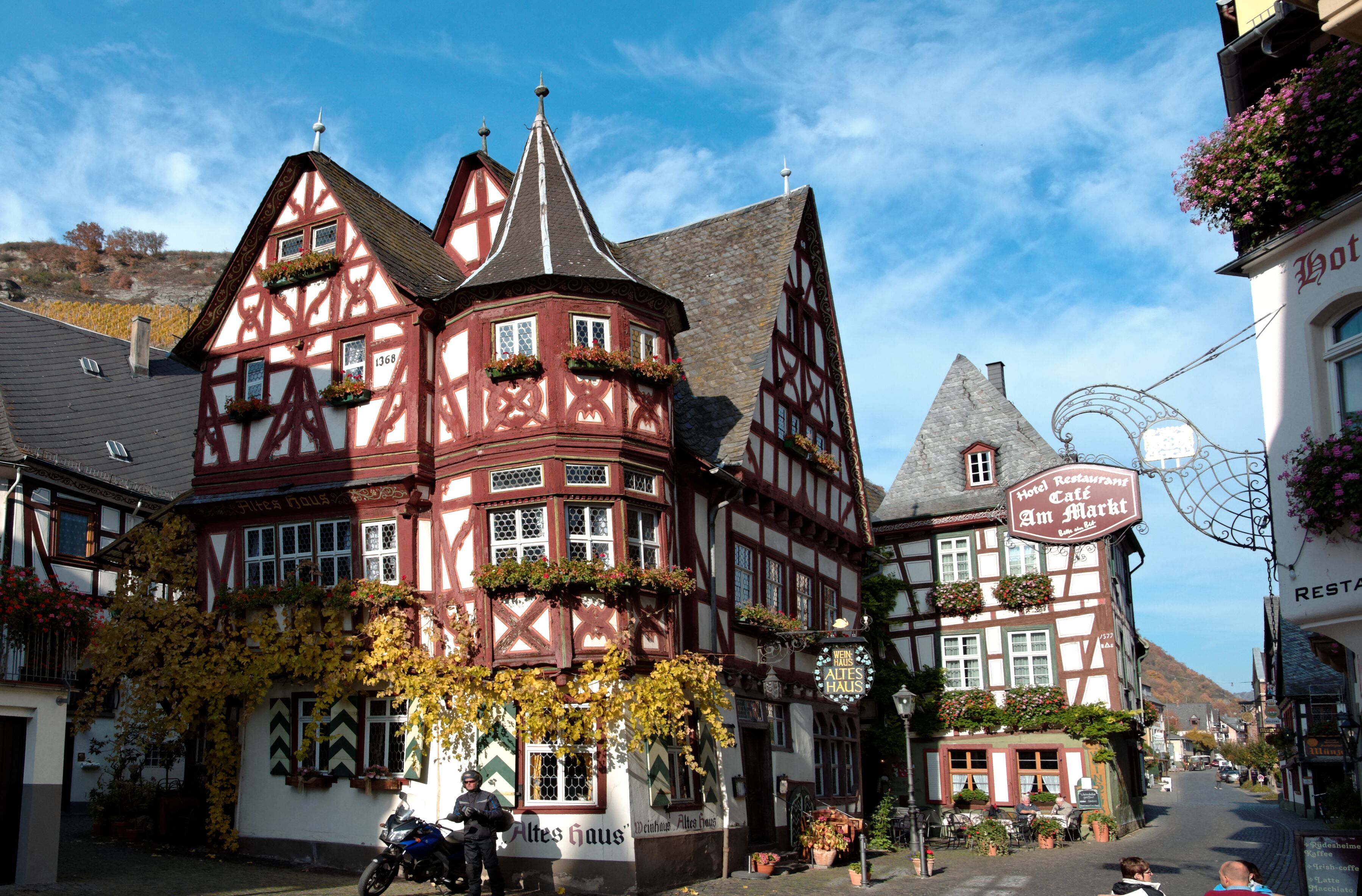A traditional half-timbered building with a sign for a hotel restaurant.