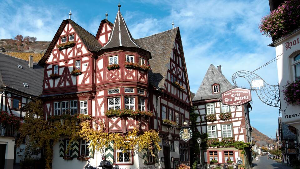 A traditional half-timbered building with a sign for a hotel restaurant.