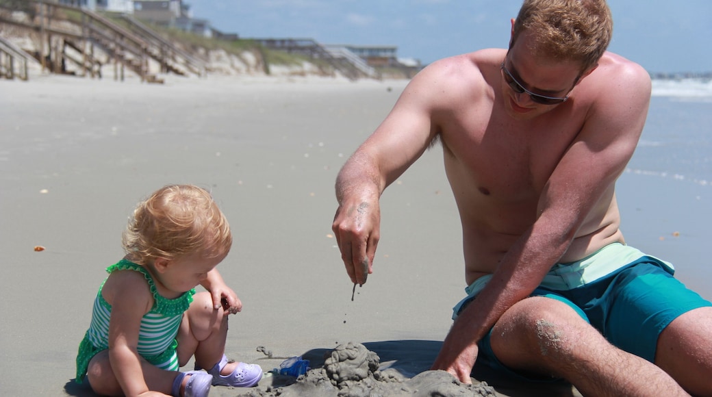 man and baby play in sand at Myrtle Beach South Carolina