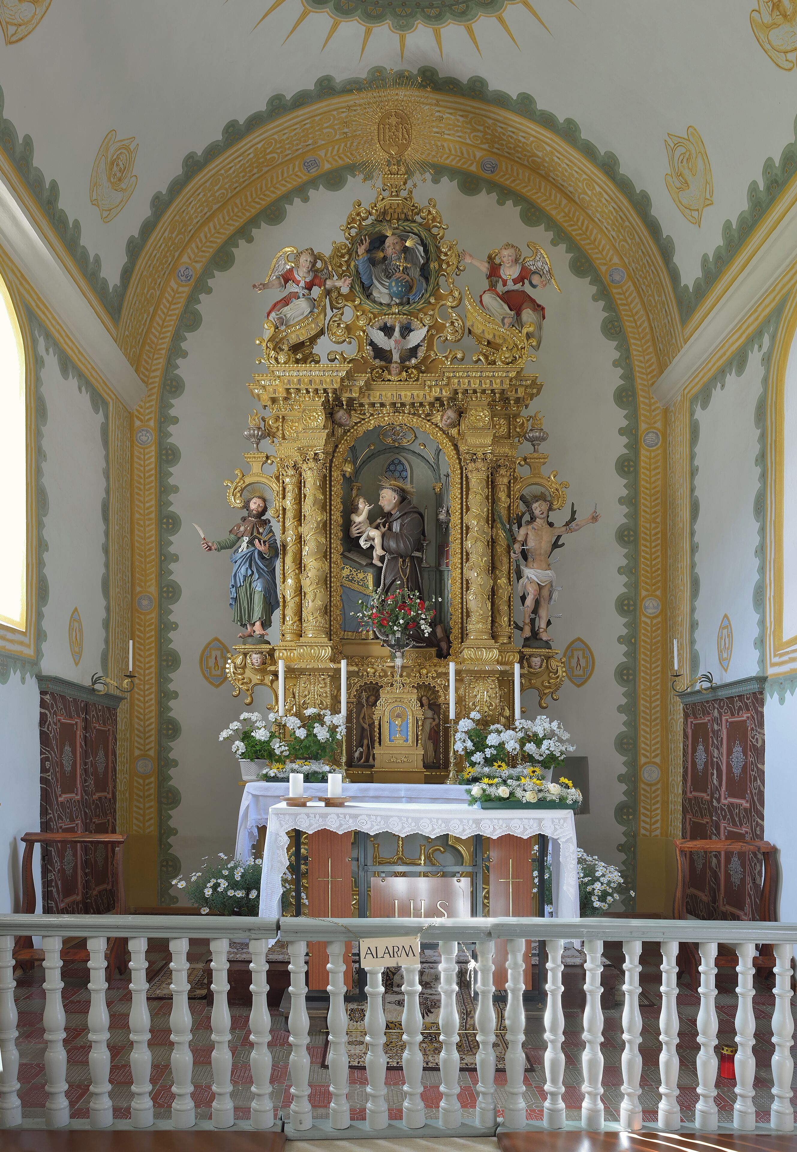 An ornate religious altar with golden decorations and statues.