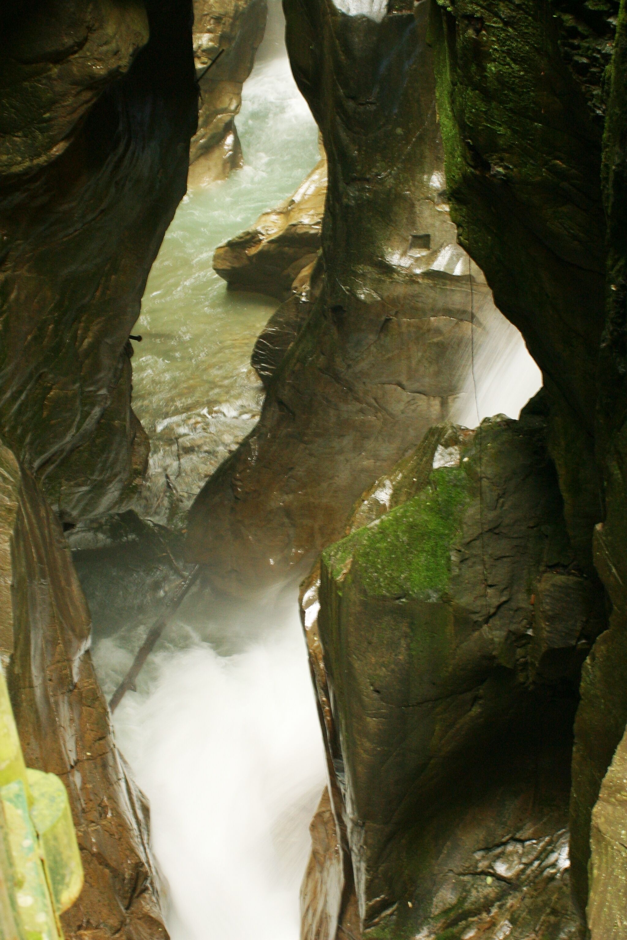 A narrow canyon with a fast-flowing river.