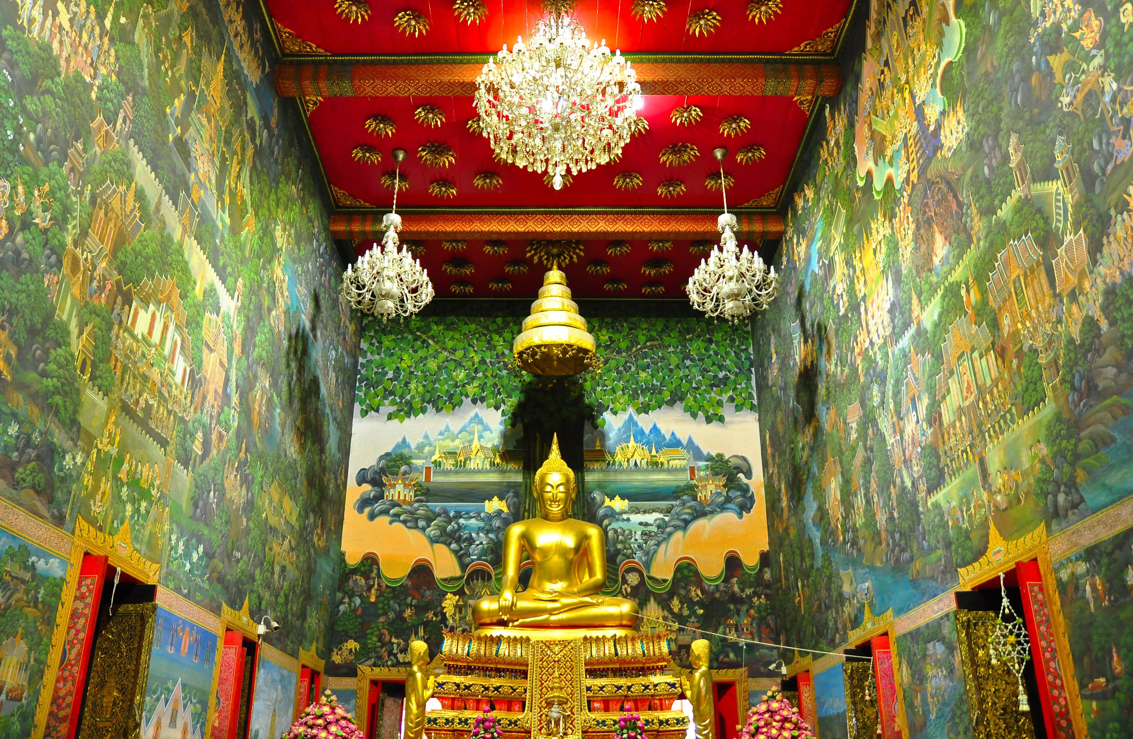 Principle Buddha image named Luang Por Wat Rai Khing in the attitude of subduing Mara posture and beautiful Thai mural painting in Wat Rai Khing temple, Nakornpathom, Thailand