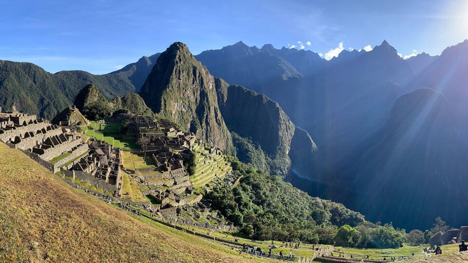 Machu Picchu, an ancient Incan city, with terraced fields and mountainous landscape.