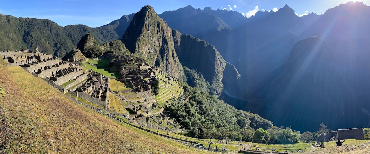 Machu Picchu, an ancient Incan city, with terraced fields and mountainous landscape.