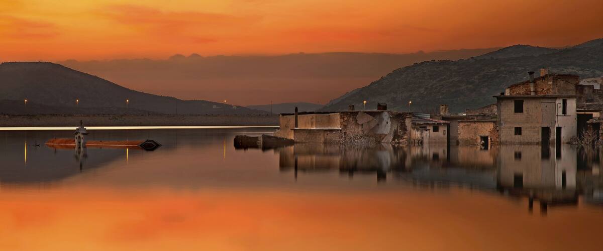 CRETE ISLAND, GREECE. Sunset at Sfendyli, the "sinking" village in the artificial lake created by the dam of Aposelemis, Hersonissos municipality, Heraklion prefecture.