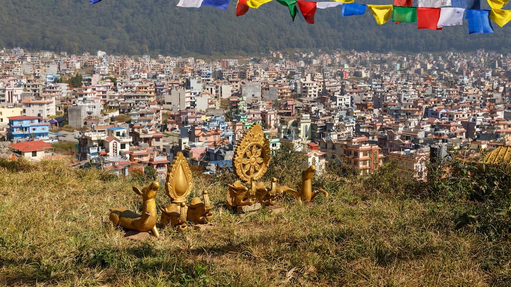 Buddhist symbols on a hill against the background of the city of Kathmandu, Nagarjun Nepal.