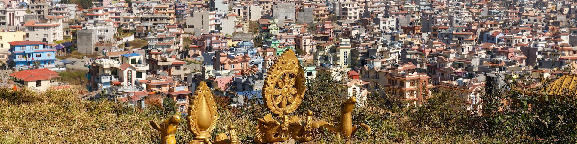 Buddhist symbols on a hill against the background of the city of Kathmandu, Nagarjun Nepal.