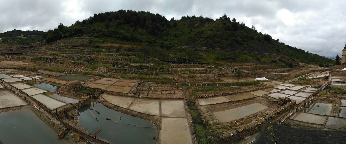 Terraced fields, a river, and a church on a hillside.