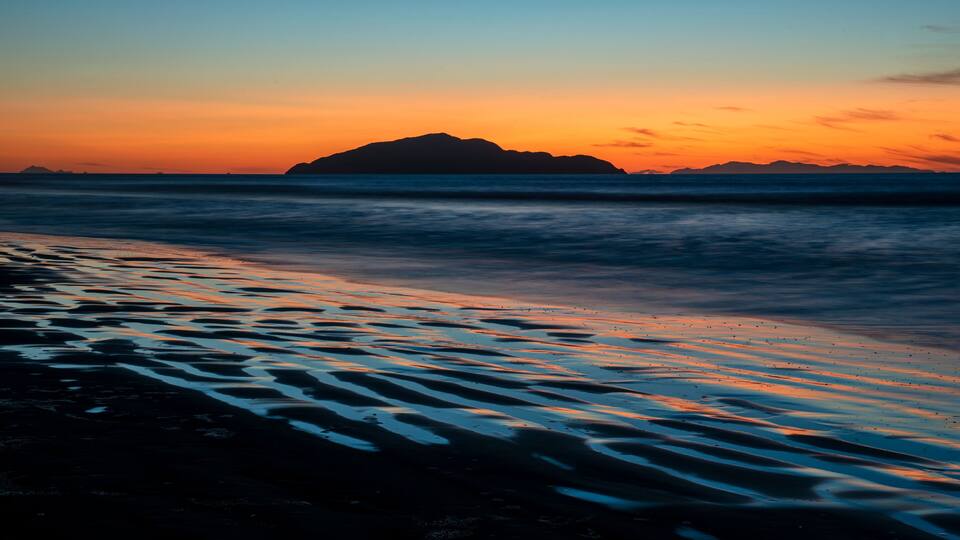 Sunset shot of Kapiti Island from Otaki beach in New Zealand with long exposure