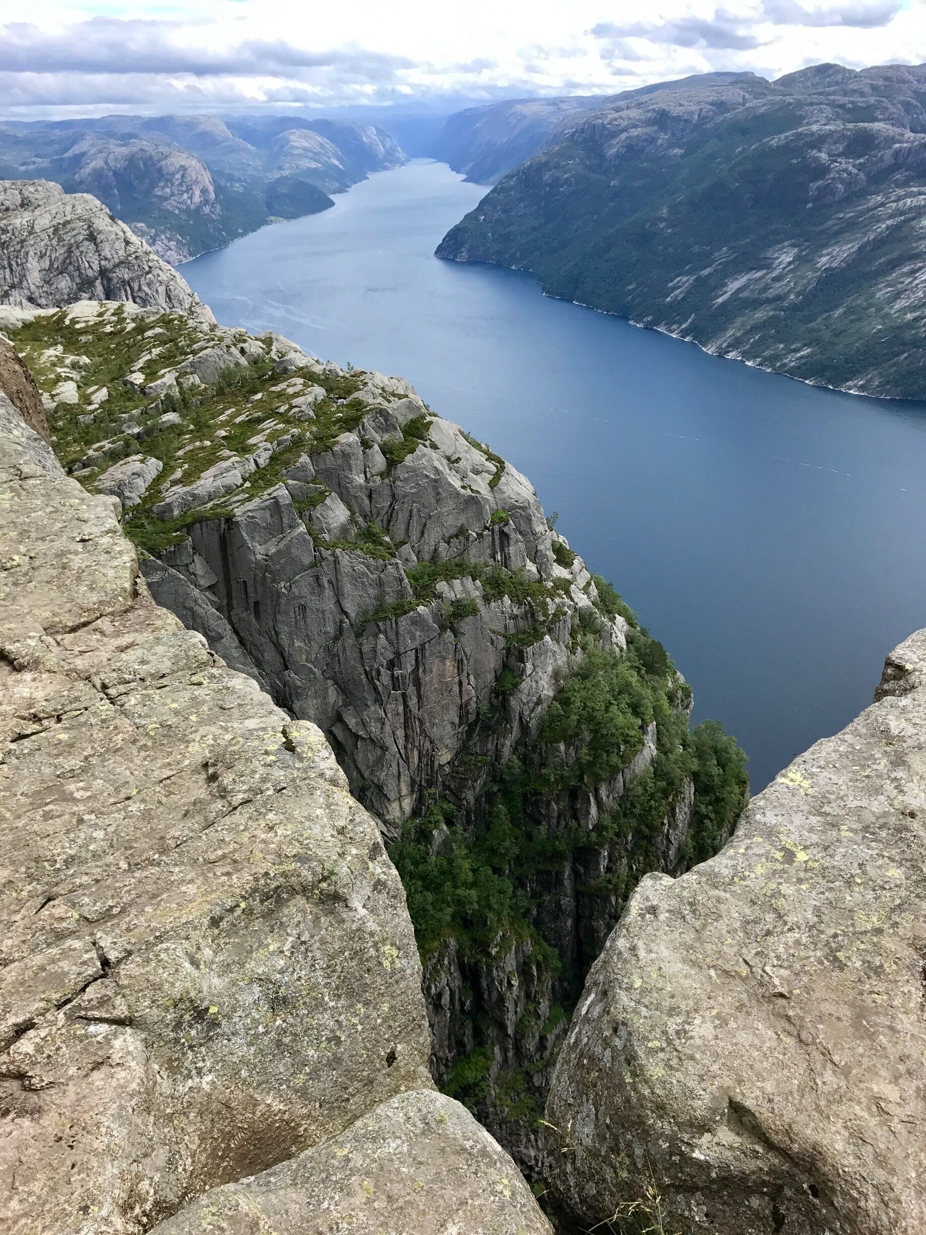A mountainous landscape with a deep valley and a large body of water.