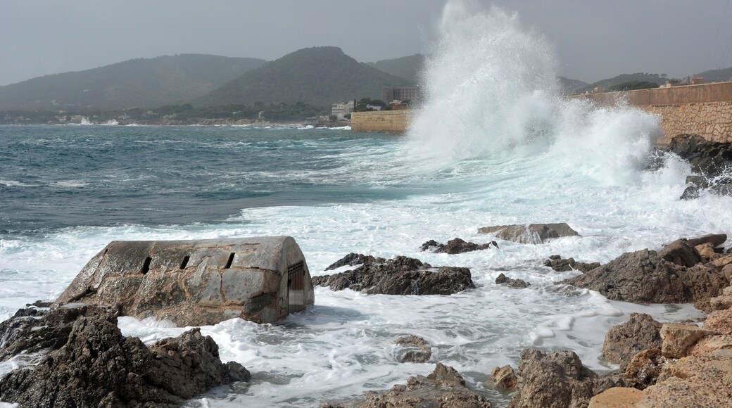 Pounding of waves against the breakwater of Cala Rajada.In the foreground a cage for keeping spiny lobsters and fishes.