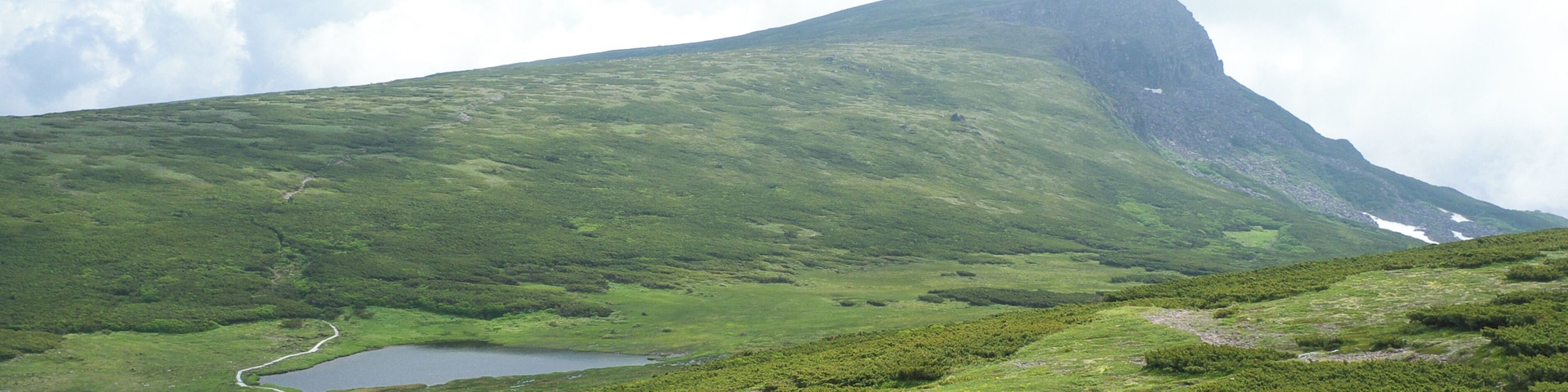 Mount Chubetsu (Chubetsu-dake) and Chubetsu Pond (Chubetsu-numa) seen from the Daisetsu Mountains traverse trail in Hokkaido, Japan