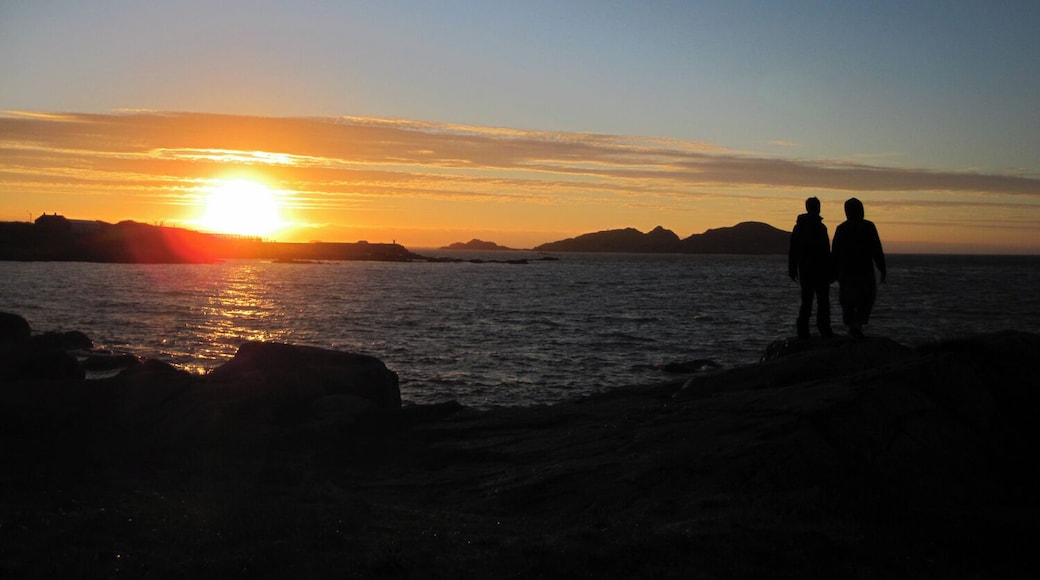 Have you experienced a 24 hour day? Hovden, on the island of Bø in Norway, is one of the places folks head to to watch the sun descend, arc against the horizon, and climb back up the other side. There are no mountains to mask the midnight sun, just open ocean. I cycled there with a couple of new friends this past summer. It was chilly, but we found ourselves taking off our shoes, increasing the sense of connection with the ground bellow us as we watched the sky above swing past.
Have a look here for another one of my experiences soaking in the dramatic lighting of summer in the arctic:
http://www.regenevieve.com/blog/norwegian-moments-moody-skies-dramatic-lighting/